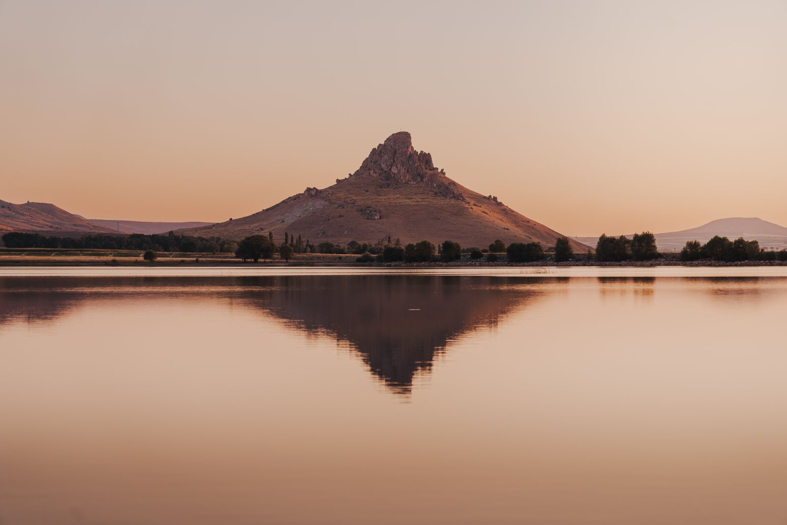 Mountain reflected in a still lake at sunrise