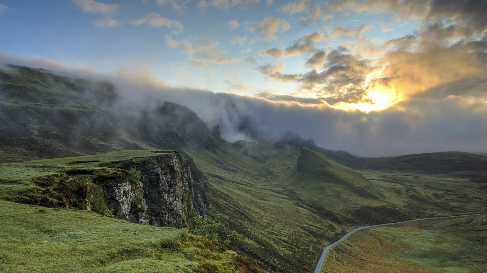 Fog-covered rolling hills at sunrise